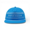 Bright blue flat‑bill hat with white horizontal stripes, a braided rope accent above the brim, and “Boston Whaler” printed on the front panel.
