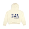 Back view of an off‑white Women's Maritime Flag Hoodie displaying a grid of navy maritime signal flag graphics above the Boston Whaler logo.